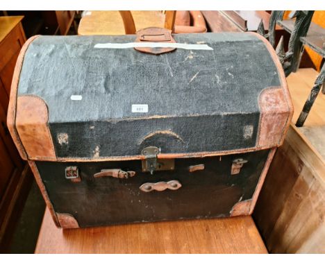 A vintage dome top and leather bound travel trunk. 