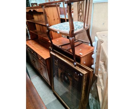 An Edwardian tub chair, a teak bookcase and a large framed print. 