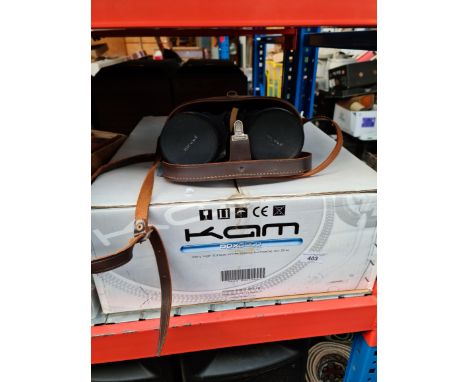 A KAM record player and a cased pair of binoculars. 