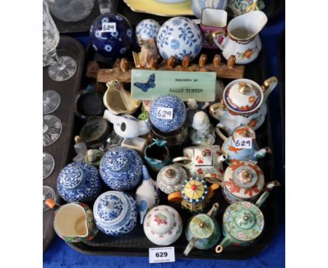 A collection of Trade + Aid enamel teapots, Dennis China Works plaque, saying designed by Sally Tuffin, assorted ornaments et