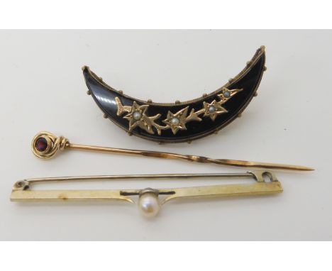 A yellow metal garnet set pin, a yellow metal pearl set pin and a mourning brooch Condition Report: Available upon request