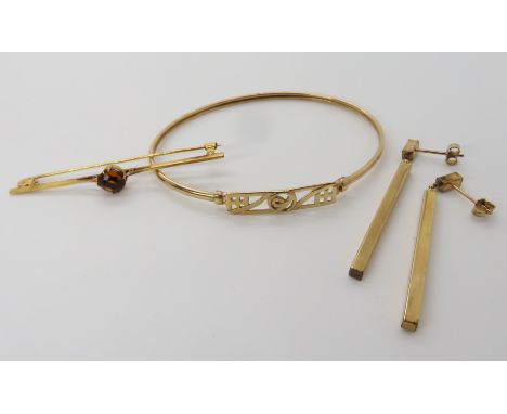 A 9ct Mackintosh style bangle, inner dimensions 6.7cm x 5.2cm, a yellow metal citrine set bar brooch and a pair of 9ct earrin