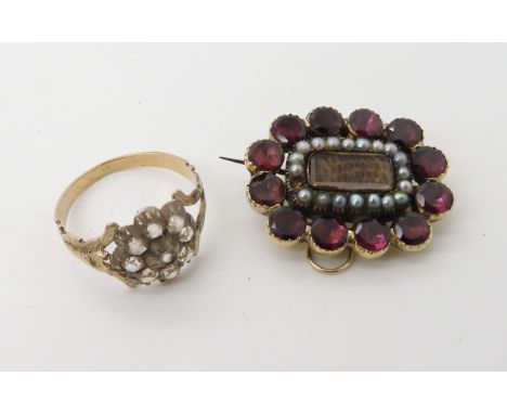 A yellow metal garnet and pearl hair mourning brooch, together with a clear gem flower ring, size P, combined weight 7.7gms C