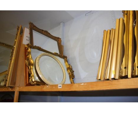 A shelf of pictures and mirrors