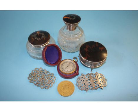 A travelling Harrods pocket barometer, three silver mounted and tortoiseshell dressing table bottles, two plated buckles etc.