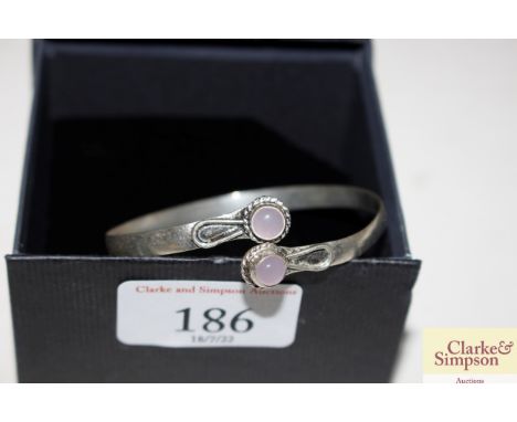 A boxed white metal and rose quartz bangle 