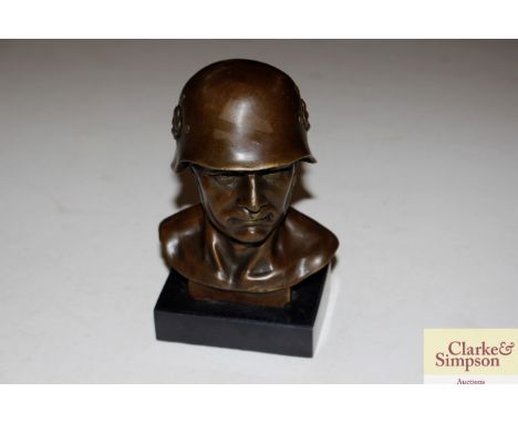 A bronze bust of a German soldier on marble plinth, signed Fisher 