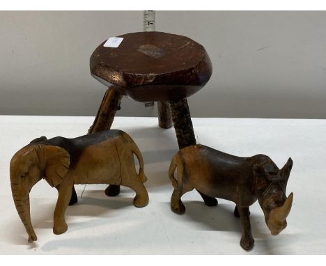 A vintage handmade small wooden stool and wooden animal figures 