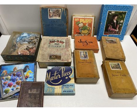 A box full of assorted mixed vintage puzzles (unchecked) 
