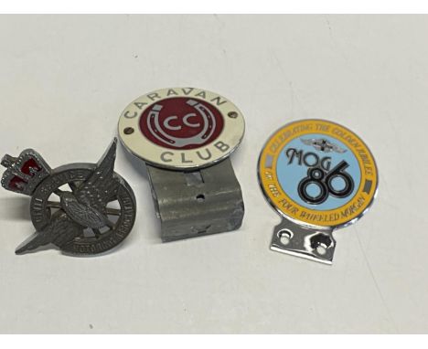 Three assorted vintage car bumper badges 
