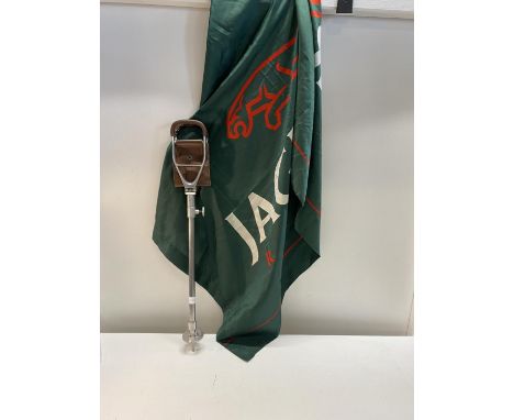 A vintage shooting stick and a large Jaguar Racing flag 