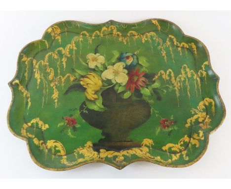 A 19th century shaped rectangular papier mache tray painted with a vase of colourful flowers within typical gilt painted bord