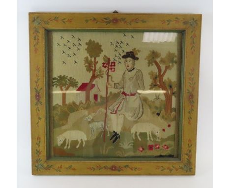 A late 19th century tapestry panel of a shepherd with dog and sheep in a painted wood frame, overall size 73cm x 75cm 
