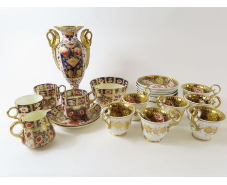 A 19th century Coalport set of six cups and saucers each with hand painted floral panels and gilt over deep blue ground, a ma