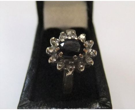 9ct yellow gold cluster ring with central large sapphire surrounded by white stonesApprox 2.5 grams gross,            size K 