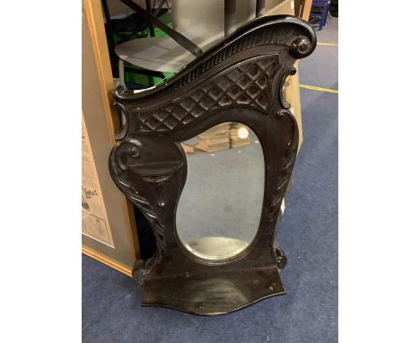 A DECORATIVE WALL MOUNTED MIRROR WITH SHELF 