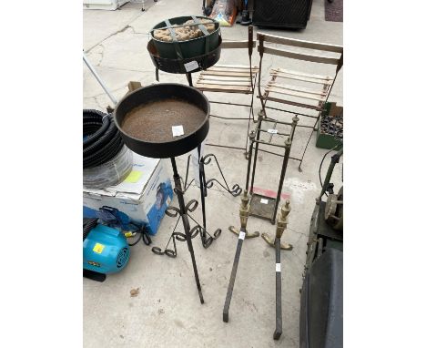 AN ASSORTMENT OF ITEMS TO INCLUDE TWO IRON PLANT STANDS, DECORATIVE BRASS FIRE DOGS AND A STICK STAND 