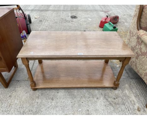 AN OAK COFFEE TABLE WITH LOWER SHELF 