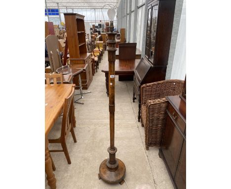 A POLISHED BEECH STANDARD LAMP WITH TURNED COLUMN 