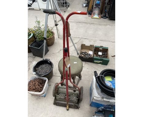 A POGO STICK, A VINTAGE PUSH LAWN MOWER AND A FOUR LEGGED STOOL 