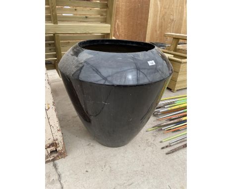 A LARGE STYLISH BLACK FIBRE GLASS URN PLANTER 