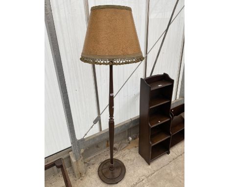 A POLISHED STANDARD LAMP COMPLETE WITH SHADE 