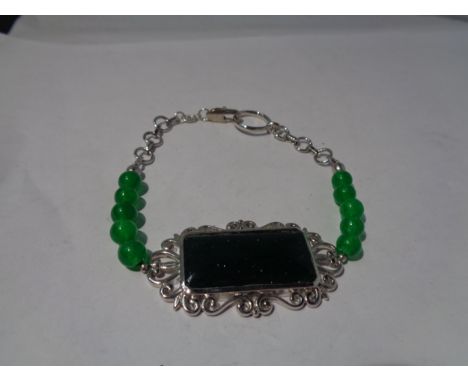 A SILVER AND JADE BRACELET 