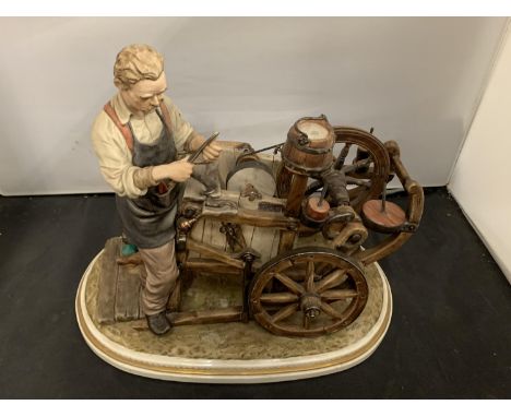 A CAPODIMONTE ORNAMENT OF A KNIFE GRINDER 1979 