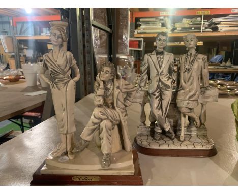 TWO GREY AND WHITE CERAMIC FIGURINES ON WOODEN PLINTHS OF COURTING COUPLES 