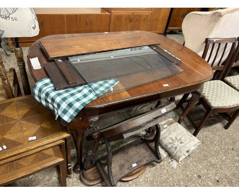 An Edwardian mahogany cabriole legged extending dining table with two extra leaves