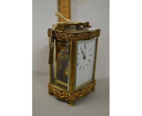 20th Century French carriage clock with serpentine case and pierced metal decoration, 12cm high