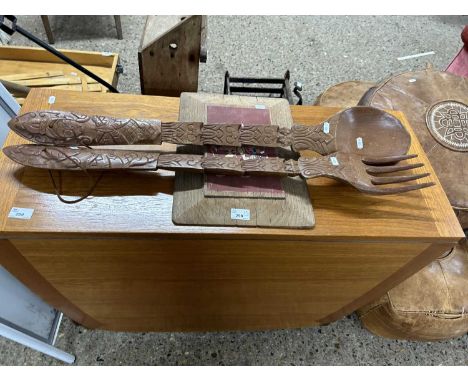 Mixed Lot: Carved tourist ware oversized spoon and fork together with a Thai painted panel
