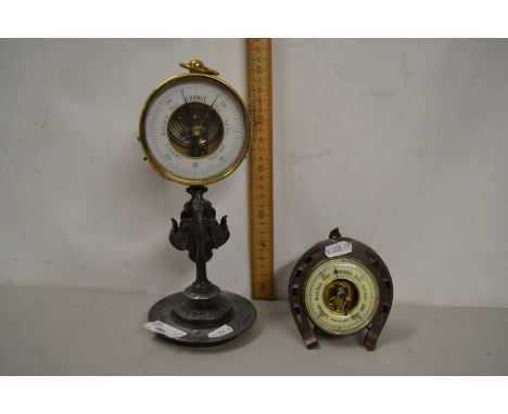 Brass cased aneroid barometer on a spelter base together with a further barometer in horseshoe shaped mount (2)