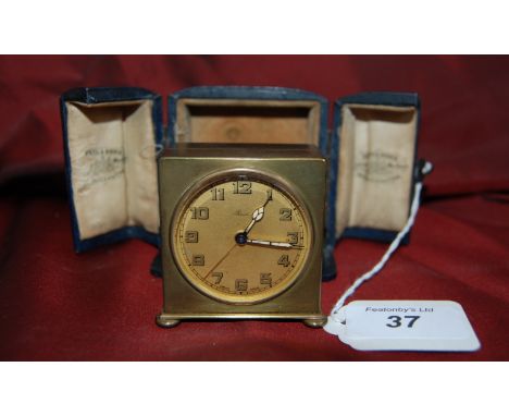 Edwardian brass travel clock with illuminated hands swiss made in a blue leather case for Reid & Sons Newcastle.