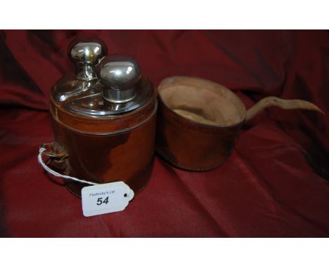 1 pr of vintage glass flasks with white metal tops in a brown leather holdall.