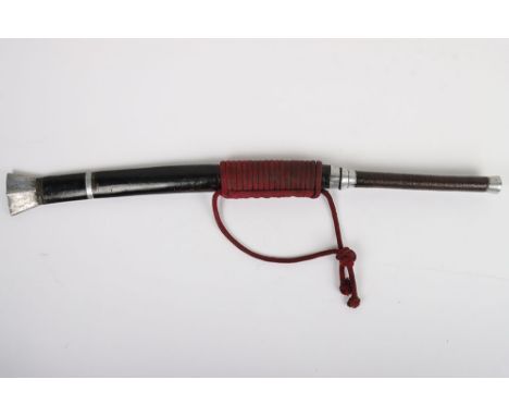 Burmese Sword Dha, with lacquered bound grip, aluminium pommel, housed in its scabbard with red rope tie. Steel swollen blade