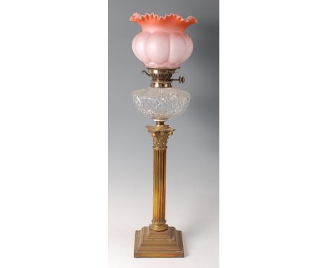 A Victorian brass Corinthian column oil lamp, having handkerchief moulded pink glass shade and cut glass font, h.73cm   Condi