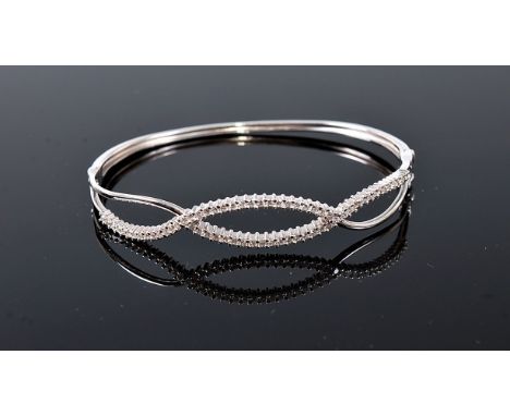 A diamond set hinged bangle, comprising of two lines of overlocking small round diamonds, total estimated weight of diamonds 