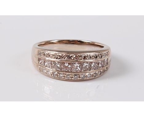 An 18ct three row diamond ring, the two outer rows of small round brilliant cut diamonds and middle row set with princess cut