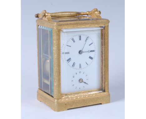 A mid-19th century gilt brass cased carriage clock, having an unsigned white enamel dial with alarm dial, push button hour an
