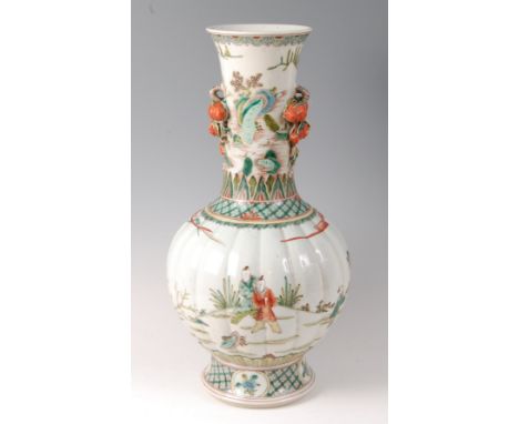 A Chinese famille verte stoneware vase, of lobed bottle shape, the neck with applied fruiting branches, the body enamel decor