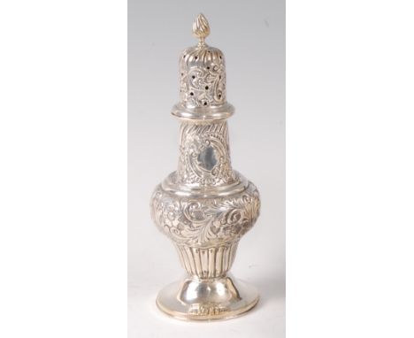 An Edwardian silver pedestal lighthouse sugar caster, having flaming torch finial topped pierced cover, with all-over leaf an