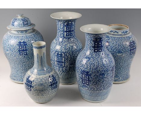 A matched set of five Chinese export blue and white vases, each decorated with Chinese symbols amidst scroll flowers and foli