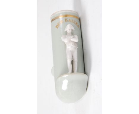 A German porcelain pipe-bowl, the lip supporting figure of Napoleon with his arms folded, gilt annotated above 'Der Kaiser', 