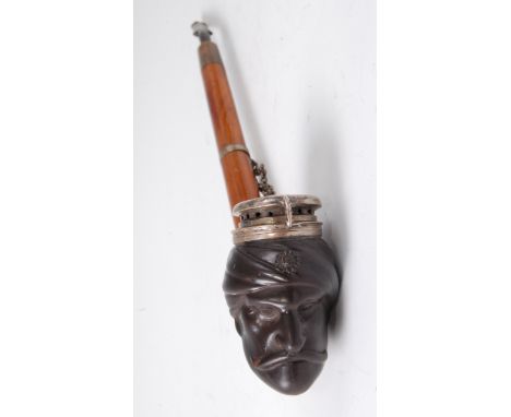 A mid-19th century German pipe, the brown stoneware bowl modelled as a 'Turks head', having white metal hinged cover, named a