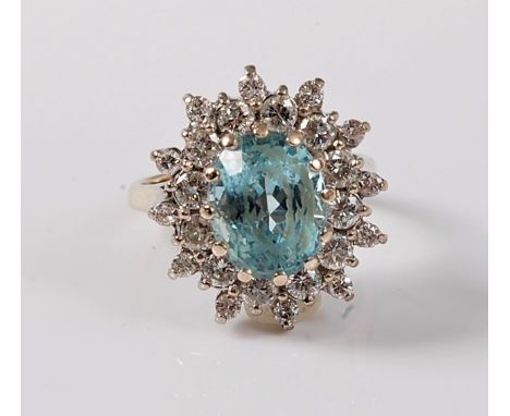 An aquamarine and diamond ring, the oval aquamarine, approx. 10.5 x 8.1mm, surrounded by two graduted rows of round brilliant