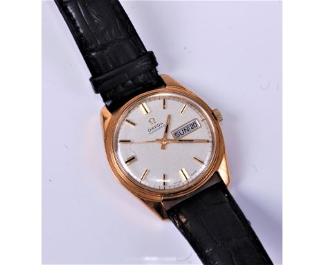 A gents 9ct gold Omega Seamaster automatic wristwatch, having day/date aperture to signed silvered dial with luminous tipped 