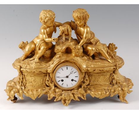 A mid-19th century French ormolu mantel clock, the case modelled as two cherubs attending to a puppy over white enamel dial, 