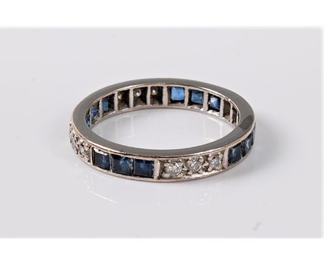 A sapphire and diamond eternity ring, the full hoop eternity ring set with alternating groups of three square sapphires and t