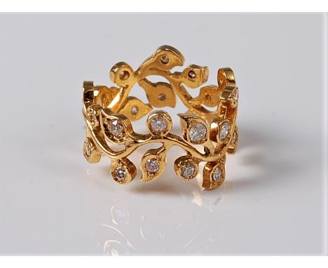 An 18ct diamond 'floral sprig' ring, the natuarlistic undulating floral sprig set with a small round brilliant cut diamond to